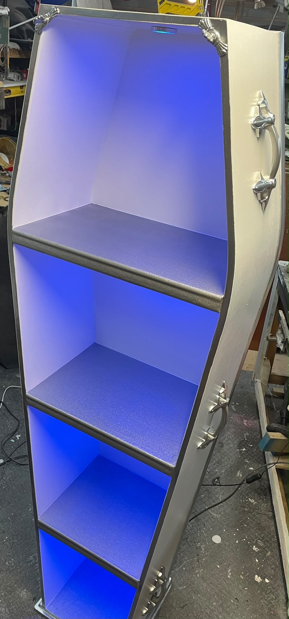 Blue coffin display shelving
